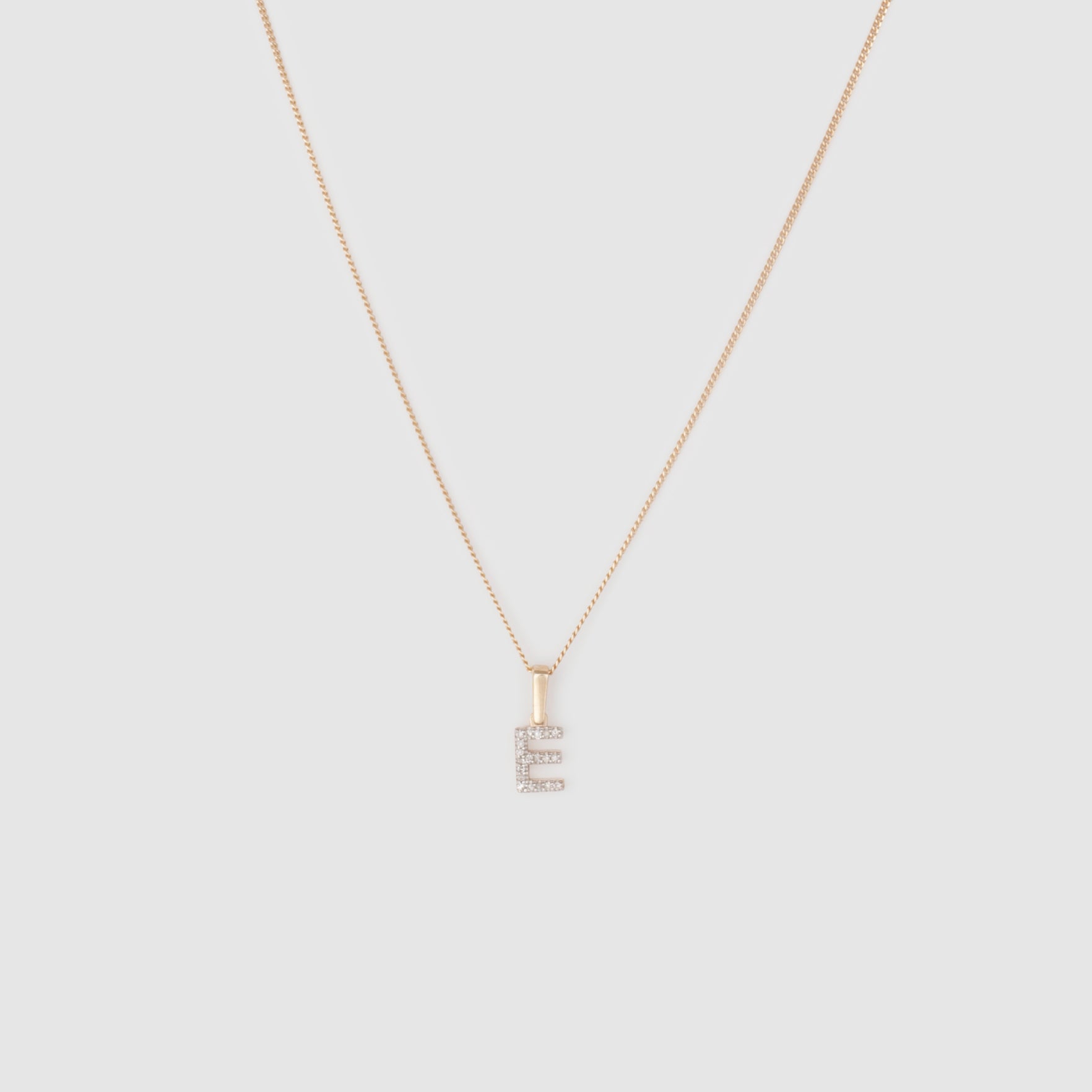 Diamond initial charm on a thin curb chain